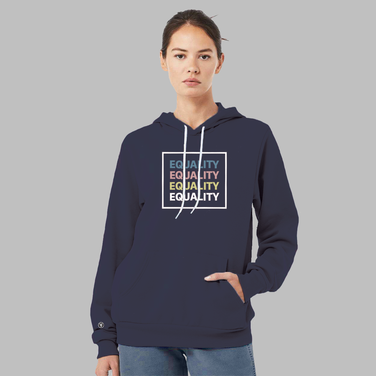 A lady wearing a navy blue equal rights hoodie with the text Equality, stacked four times, in Slate Blue, Dusty Rose, Bisque Gold, and white. The text is in bold font and is outlined by a white square.