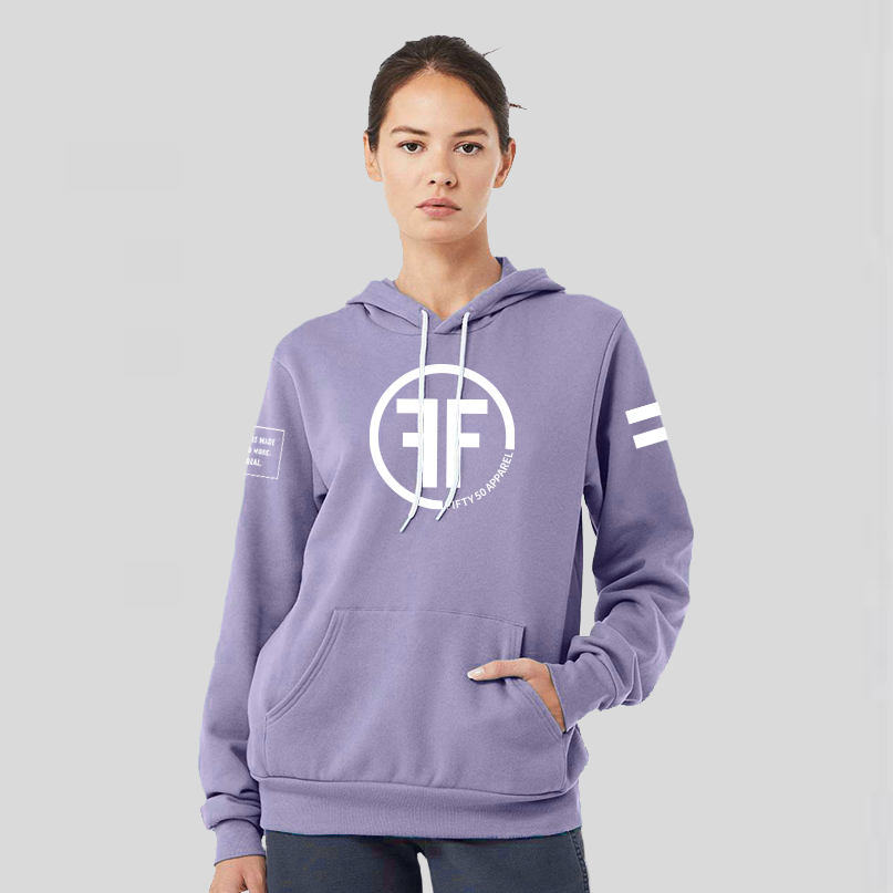 A lady wearing a lavender equality hoodie with a white equal sign on left arm, and the text, Fifty 50 Apparel is made for equality, no more, no less, just equal, on the right arm. Center chest logo has two Fs, back to back outlined by a circle.