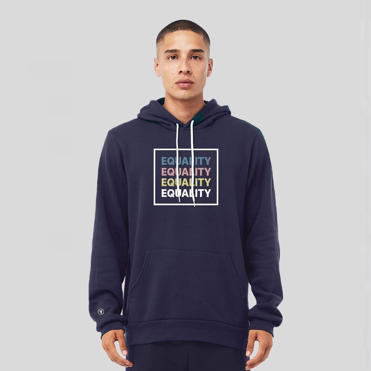 A man wearing a navy blue equal rights hoodie with the text Equality, stacked four times, in Slate Blue, Dusty Rose, Bisque Gold, and white. The text is in bold font and is outlined by a white square.