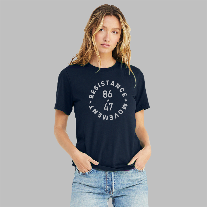 A lady wearing a navy blue unisex political t-shirt. The grey text says "86 47"in the middle with"Resistance Movement" around it.