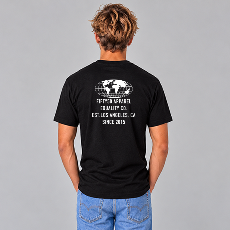 A man viewed from behind wearing a black t-shirt with a white graphic print on the back of a globe and the text 'FIFTY50 APPAREL EQUALITY CO, LOS ANGELES, CA, SINCE 2015, paired with blue jeans, against a solid gray studio background.