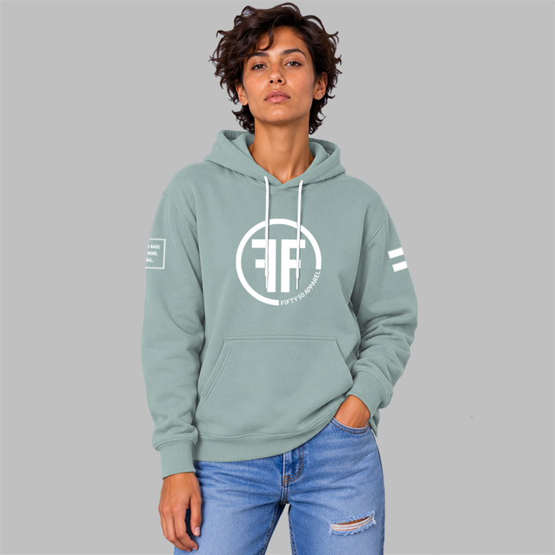 A woman wearing adusty green equality hoodie with a white equal sign on left arm, and the text, Fifty 50 Apparel is made for equality, no more, no less, just equal, on the right arm. Center chest logo has two Fs, back to back outlined by a circle.