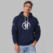 A man wearing a navy blue equality hoodie with a white equal sign on left arm, and the text, 'Fifty 50 Apparel is made for equality, no more, no less, just equal', on the right arm. Center chest logo has two Fs, back to back outlined by a circle.