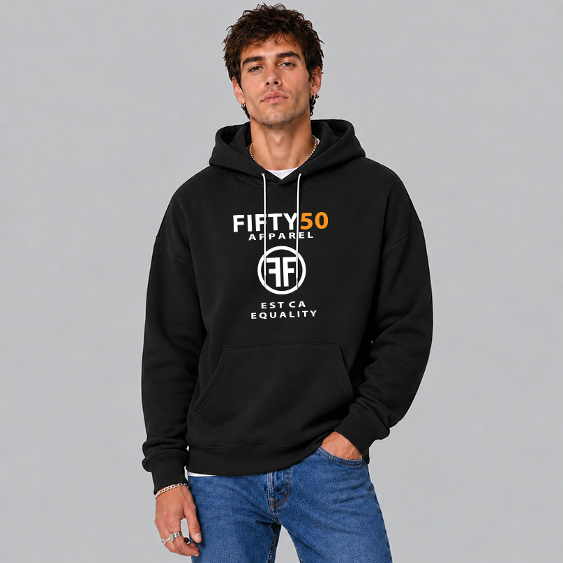 A man wearing a black hoodie with the text, Fifty 50 Apparel and Est Ca Equality in white, bold font. The 50 is in orange ink and the center of the logo has two Fs, back to back in a circle, paired with blue jeans against a studio background.