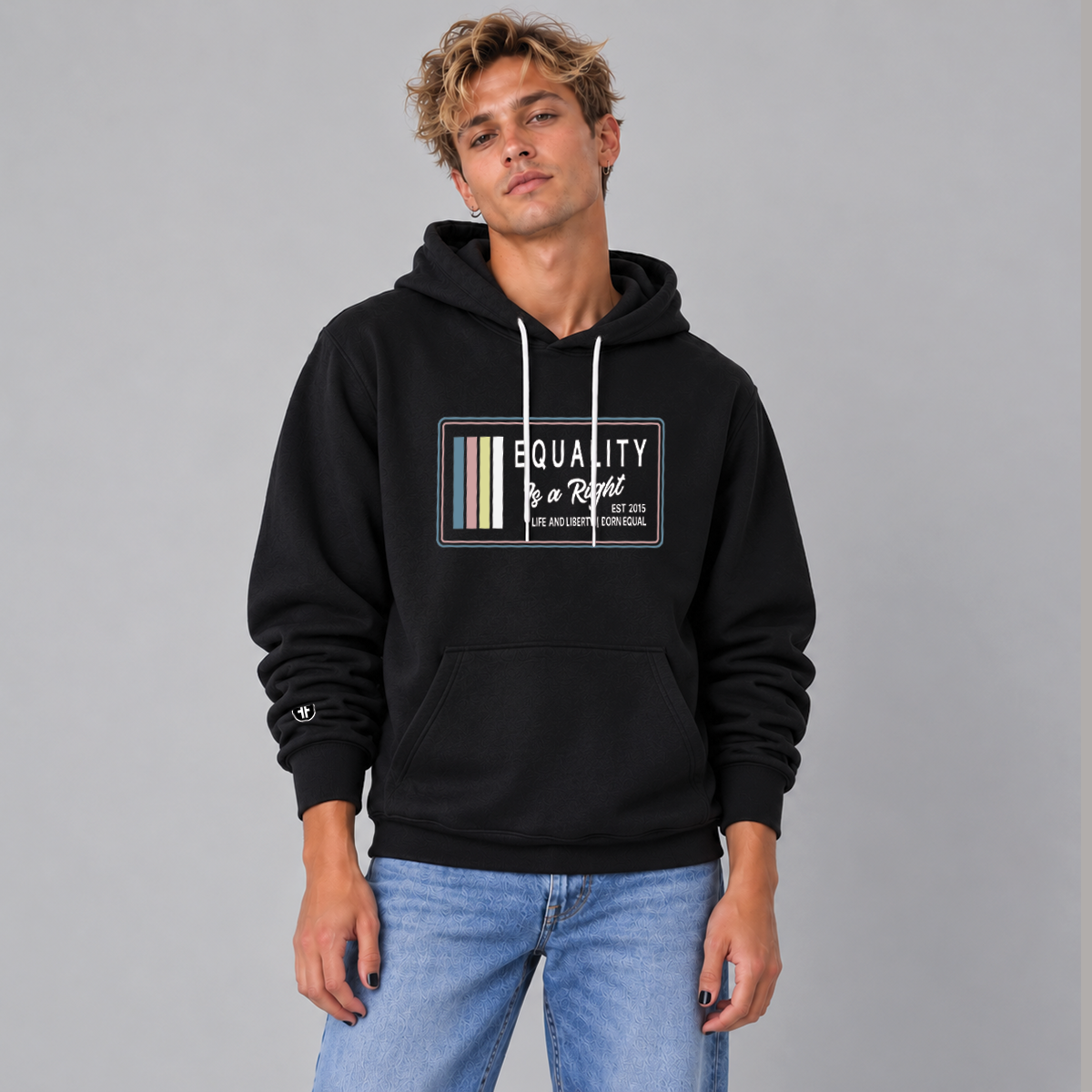 A man wearing a black pullover hoodie with a graphic print on the chest that reads 'EQUALITY IS A RIGHT LIFE AND LIBERTY BORN EQUAL' 