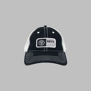A black trucker with white mesh side panels and white contrast stitching. The rectangular patch is white, grey and black with the text Fifty Fifty.