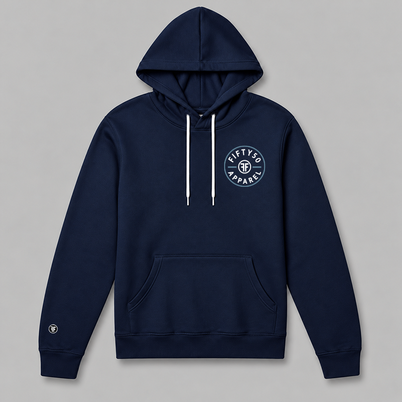 A navy blue pullover hoodie with a circular left chest logo graphic that reads 'FIFTY50 APPAREL' in white, with a Slate Blue circle around it. The middle of the graphic has two white Fs back to back.