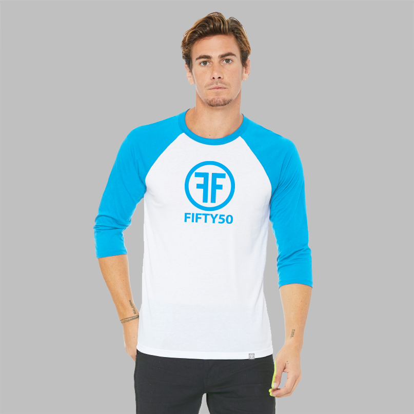 A man wearing a white baseball equality t-shirt with a turquoise collar and arms. The logo is turquoise with two Fs, back to back in the middle of a circle with the text, Fifty50 below it.
