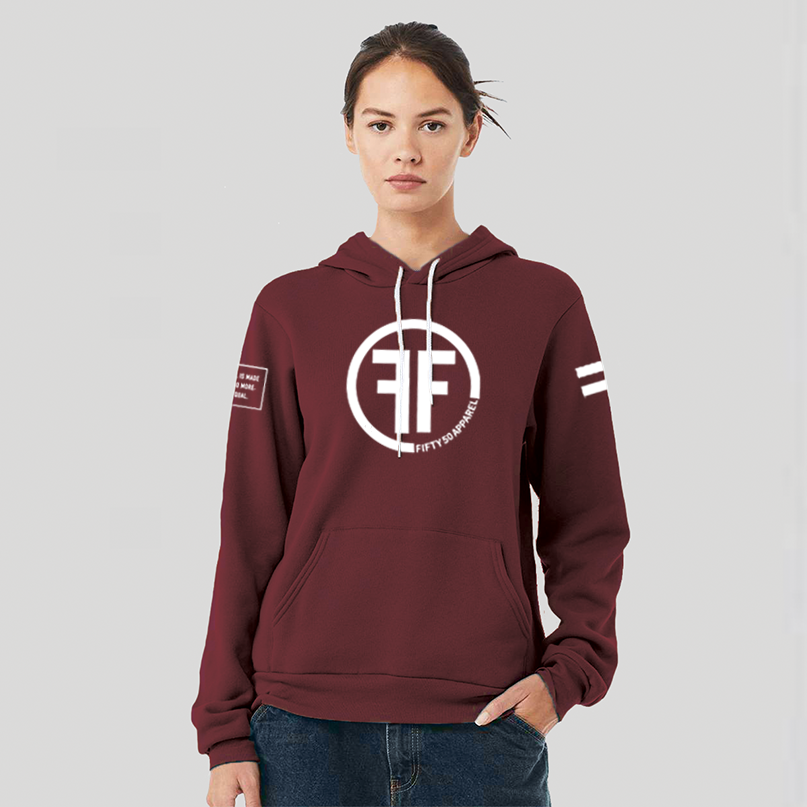 A lady wearing a maroon equality hoodie with a white equal sign on left arm, and the text, Fifty 50 Apparel is made for equality, no more, no less, just equal, on the right arm. Center chest logo has two Fs, back to back outlined by a circle.