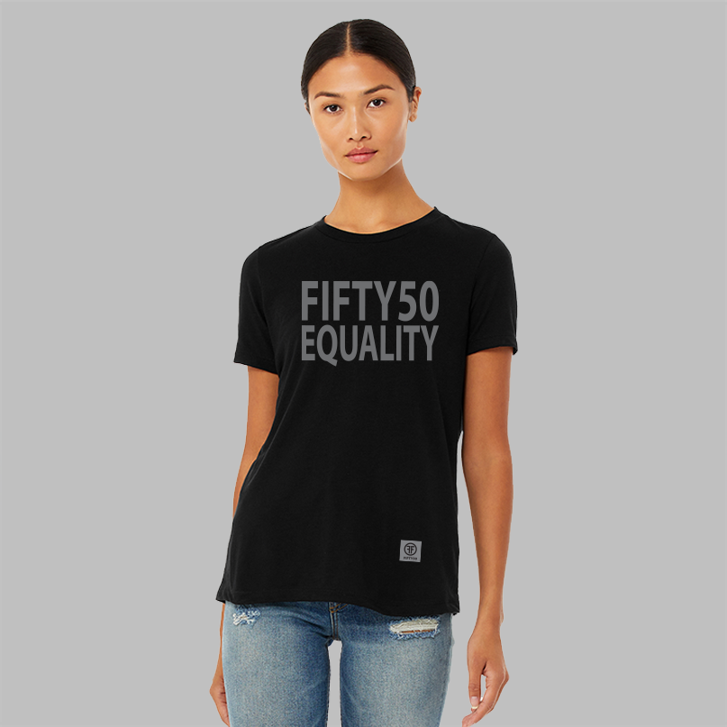 A lady wearing a black equality tshirt. The text is in large, grey, bold font and says Fifty50 with Equality below it. 