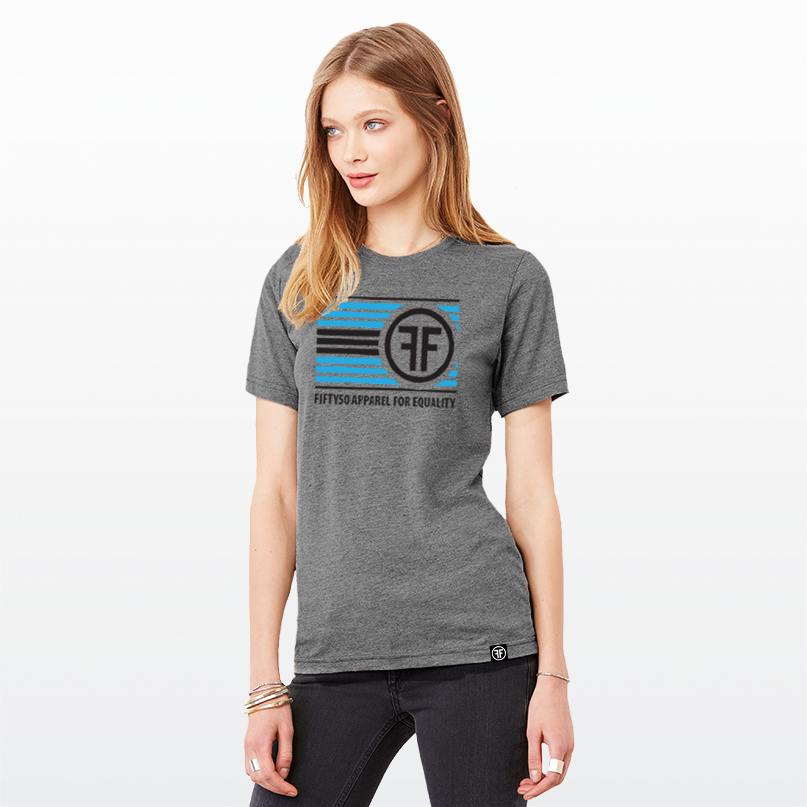 A lady wearing a grey equality t-shirt. The logo has turquoise and black stripes, with two Fs, back to back, and the text, Fifty50 Apparel For Equality.