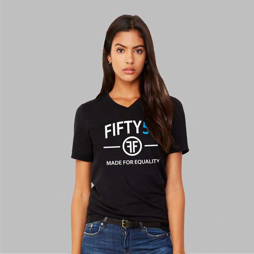 A lady wearing a black v-neck t-shirt with a logo. The text on the tee is in white and turquoise and reads Fifty50 and Made for Equality.