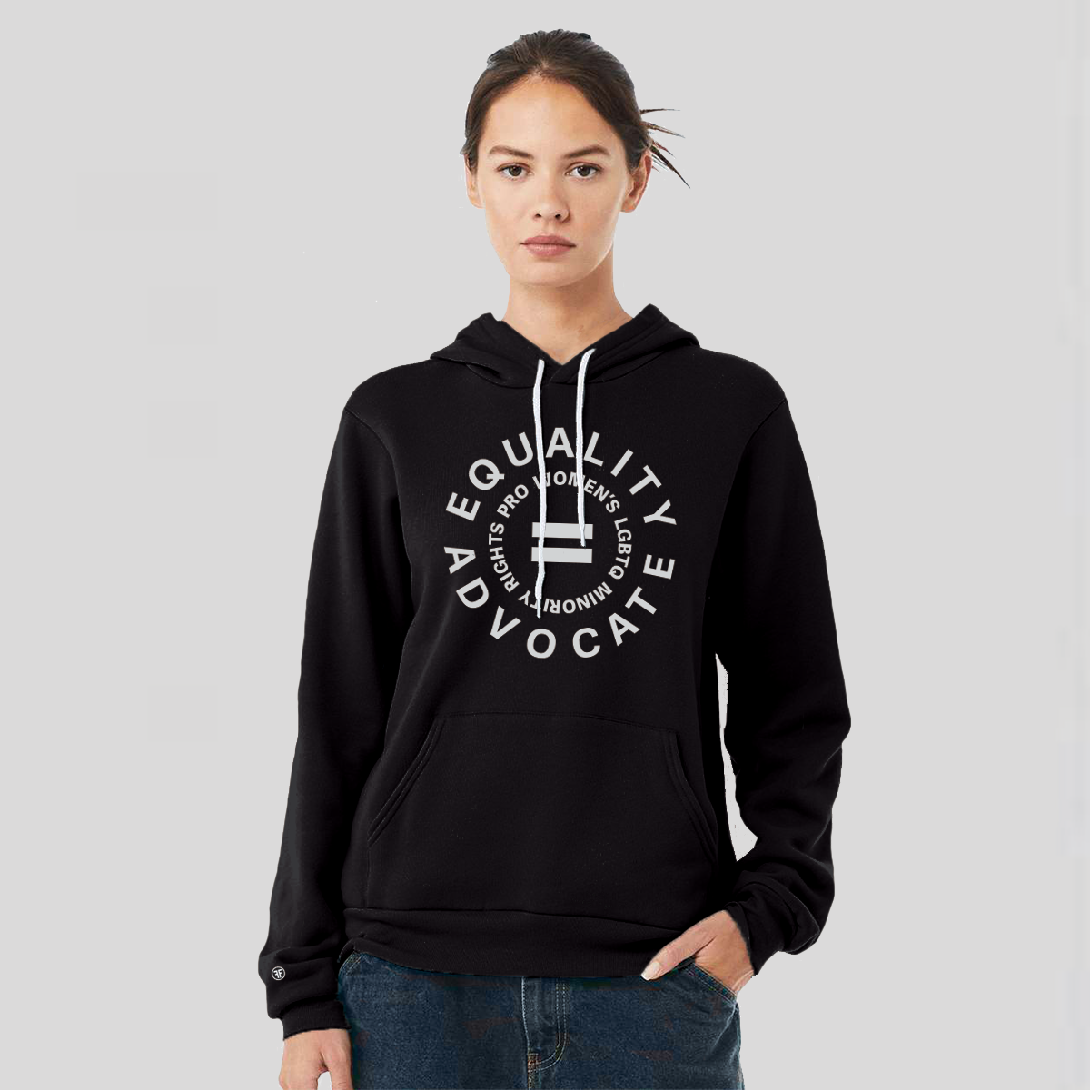 A lady wearing an equal rights, black hoodie, with a light grey logo. An equal sign is in the middle with the text Equality Advocate, pro women's, LGBTQ, & racial rights around it.