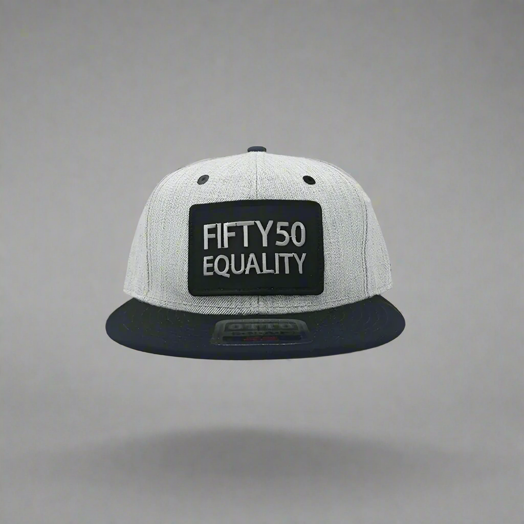 A black flat bill equality hat with a black bill and eyelets. It has a sewn on black patch that has the embroidered text Fifty50, Equality, in bold, grey font.