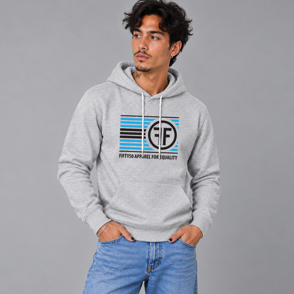 A man wearing an ash grey pullover hoodie with the text 'FIFTY50 APPAREL FOR EQUALITY' in black that has turquoise and black horizontal lines with the Fifty50 logo in black to the left of the lines.