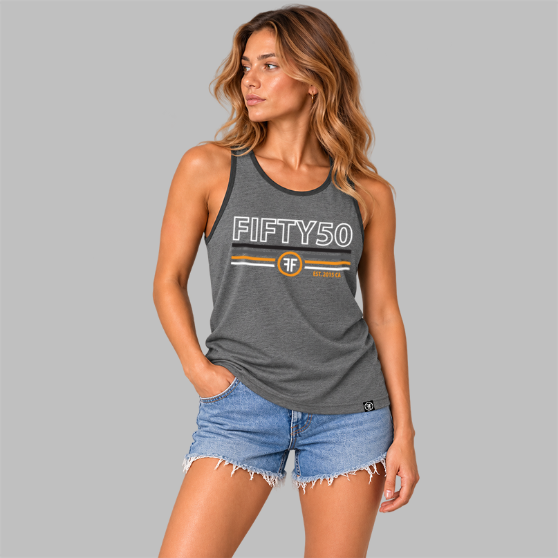 A  woman wearing a heather gray sleeveless tank top with black trim and a graphic print on the front reading 'FIFTY50' with horizontal stripes in black, charcoal grey, orange and white and a circular FF logo, shown on a plain gray background.