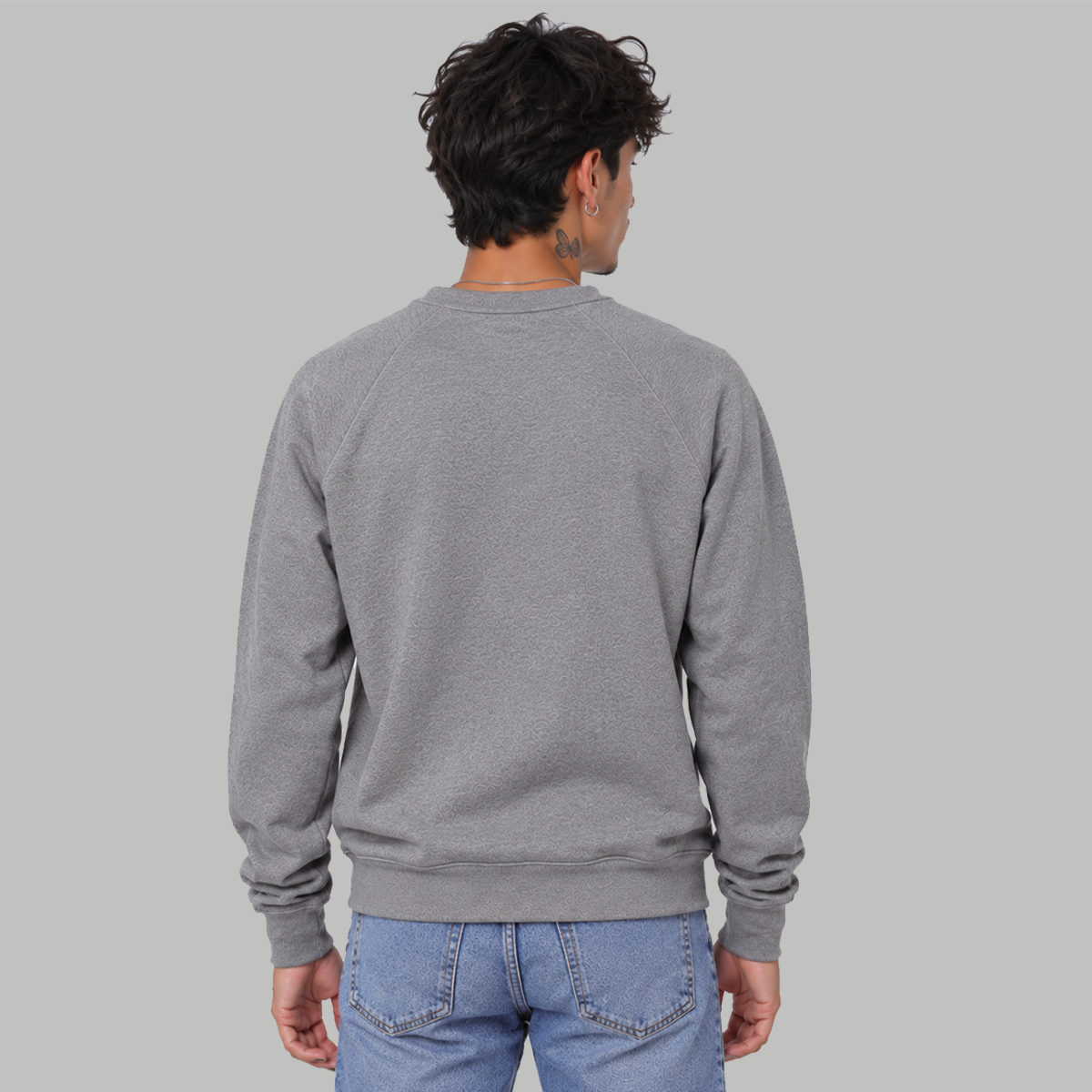 The back of a man wearing an ash grey, raglan crew sweatshirt with no logo or graphic 