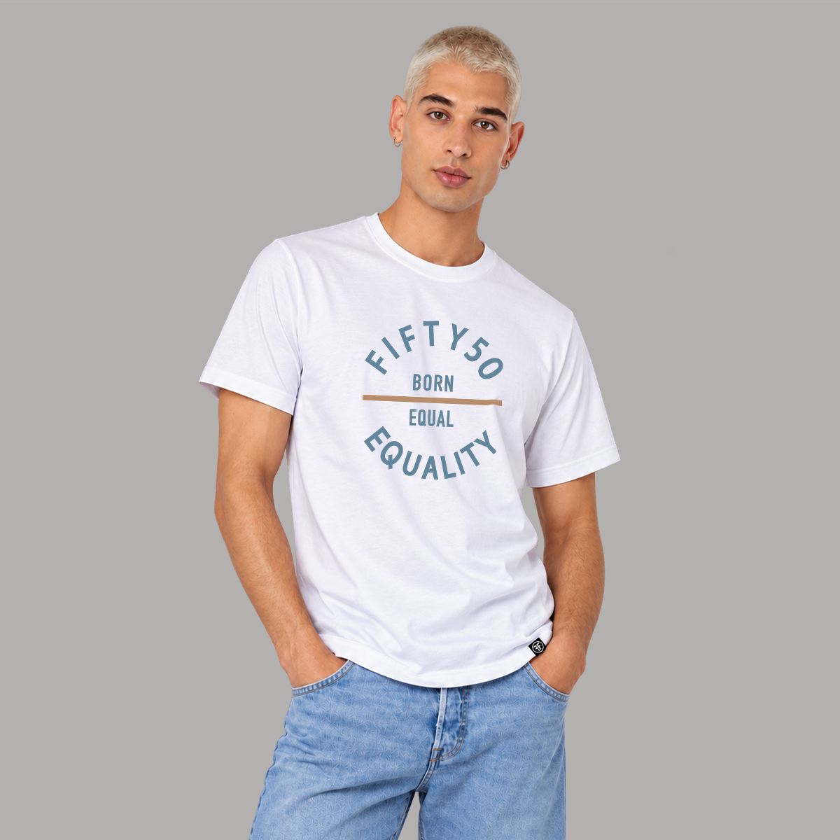 A man wearing a white short-sleeve graphic t-shirt with blue jeans, standing against a solid gray background. The t-shirt features a blue graphic text layout that reads 'FIFTYSO BORN EQUAL EQUALITY' with a thin horizontal soft orande line in the center.