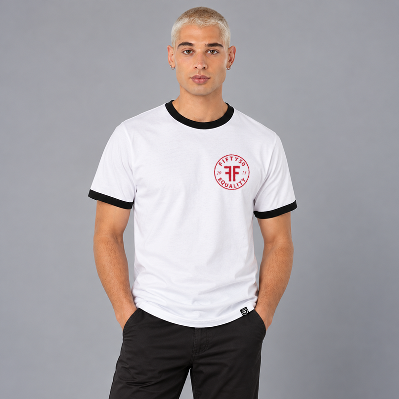 A man wearing a white ringer t-shirt with black trim on the collar and cuffs, featuring a red circular chest graphic that reads 'FIFTY50 EQUALITY 2015'.