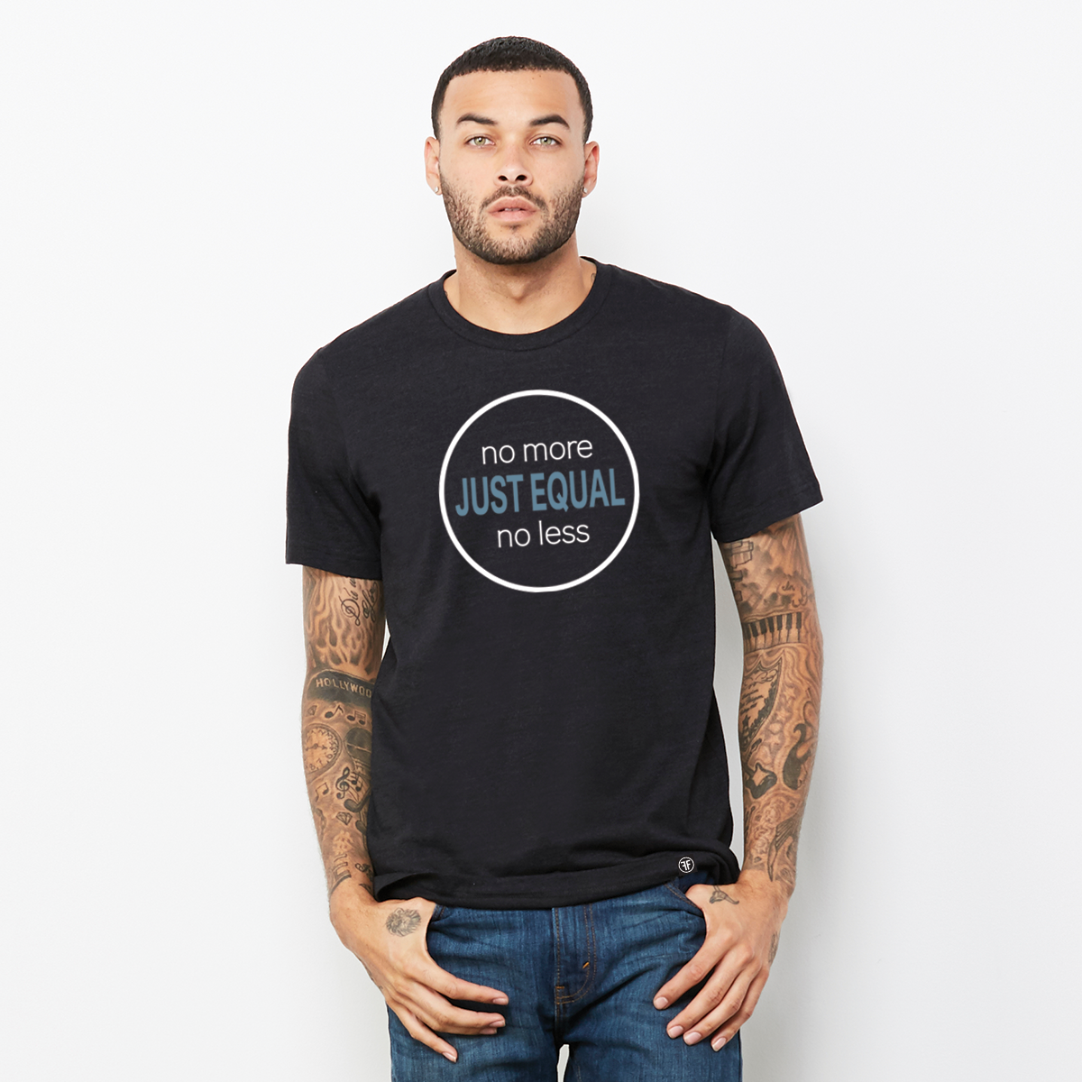 Man wearing a black t-shirt with the words Just Equal in Slate Blue, bold font. In white text above, No More, and below, No Less. All outlined by a white circle. A white equal sign is on the left sleeve.
