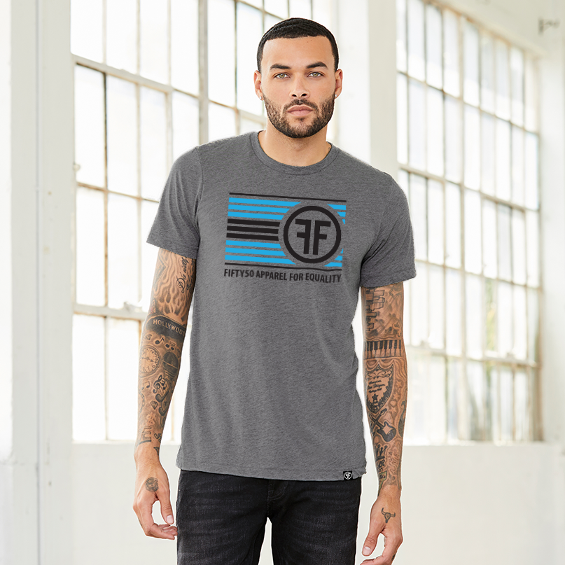 A man wearing a grey equality t-shirt. The logo has turquoise and black stripes, with two Fs, back to back, and the text, Fifty50 Apparel For Equality.