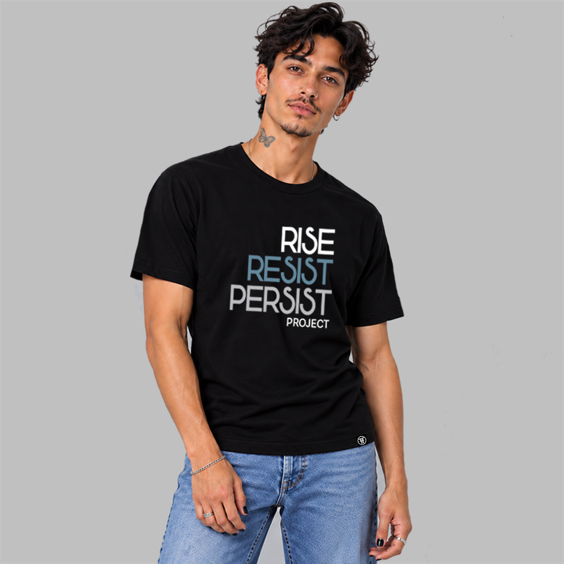 A man wearing a black graphic t-shirt with the text 'RISE RESIST PERSIST PROJECT' in white, slate blue, and light grey, paired with light blue jeans, against a solid gray background.