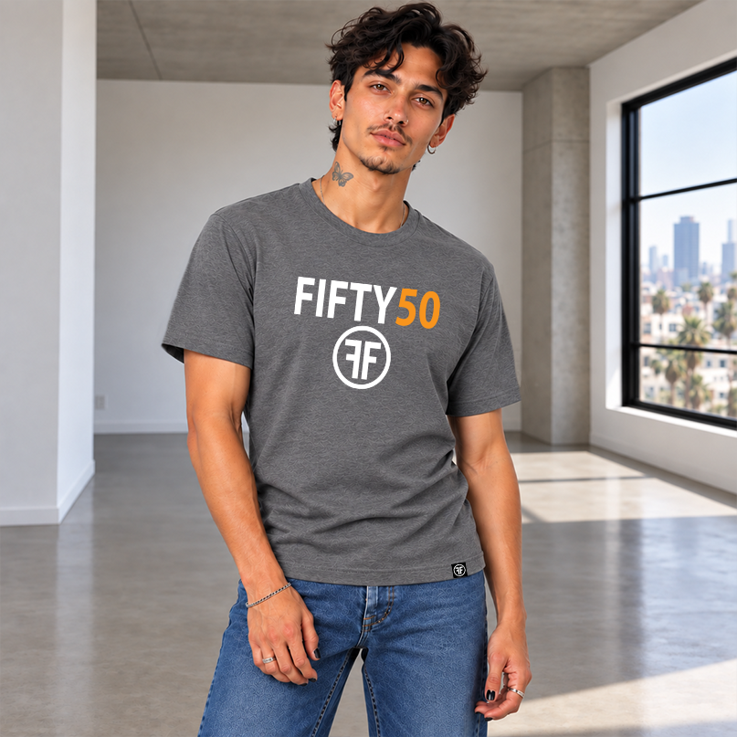 A man modeling a dark heather gray t-shirt with 'FIFTY50' and a circular 'FF' logo printed on the chest, paired with blue jeans against a solid gray background.