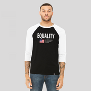 A man wearing an equality black baseball t-shirt with white arms and collar. The logo has the text, Equality, written in white bold font, and an American flag and the text, A fifty 50 America created for all.