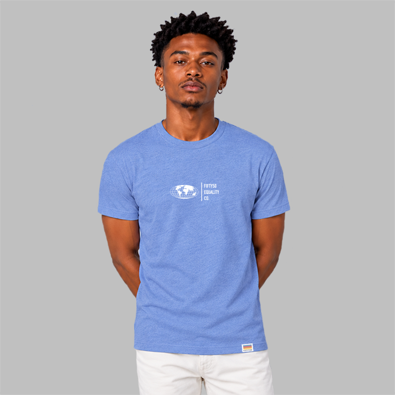 A man wearing a  blue short-sleeve t-shirt with a white graphic center chest featuring a globe and the text 'FIFTYT50 EQUALITY CO. Paired with white pants, set against a solid gray background.