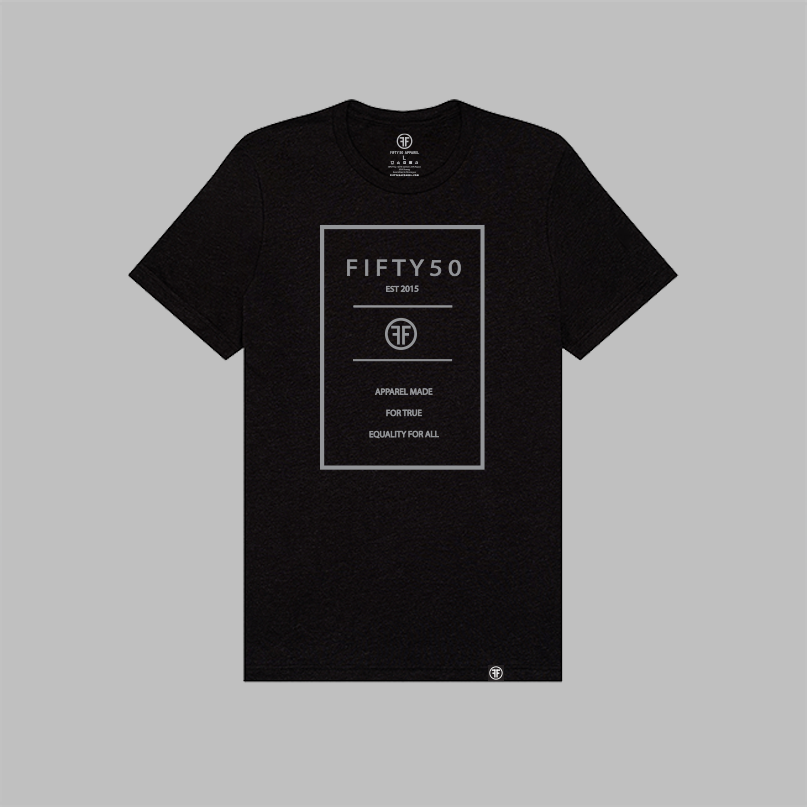 A black short-sleeve crewneck t-shirt with a light grey graphic print on the front reading 'FIFTY50 EST 2015, MADE FOR TRUE EQUALITY FOR ALL' inside a thin rectangular border, shown on a solid gray background.
