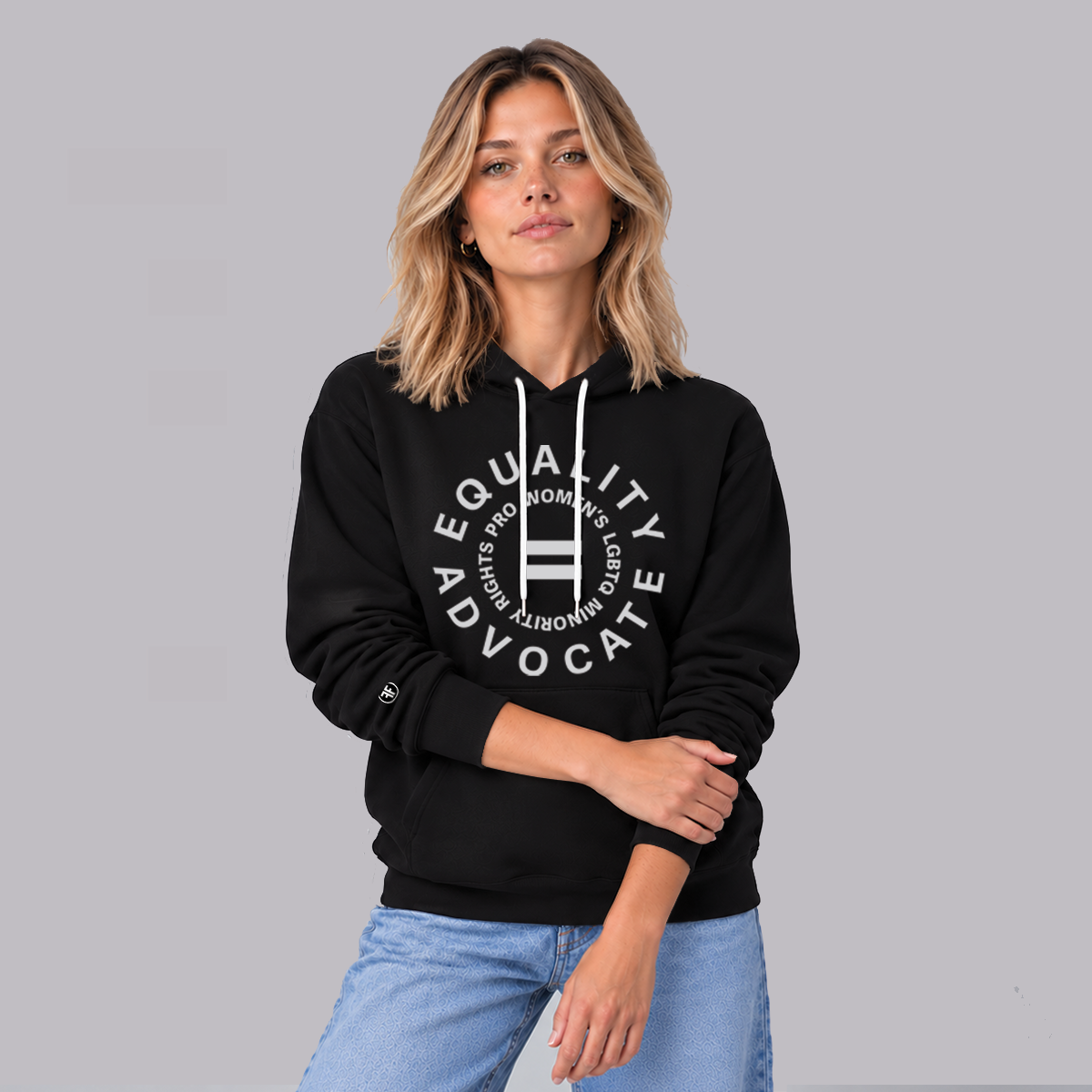 A woman wearing an equal rights, black hoodie, with a light grey logo. An equal sign is in the middle with the text Equality Advocate, pro women's, LGBTQ, & racial rights around it.