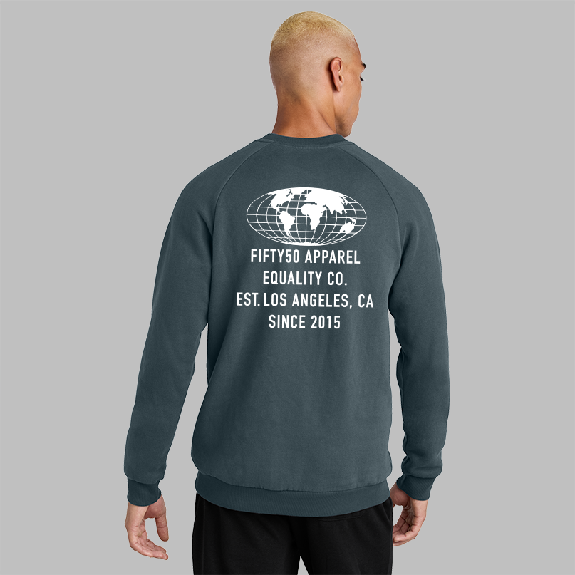 A man viewed from the back wearing a dark slate blue crewneck sweatshirt with a white graphic print on the back. The print features a globe design and the text 'FIFTY50 APPAREL EQUALITY CO.