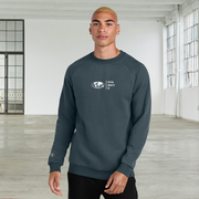 A man modeling a dark slate blue crewneck sweatshirt with a globe and a white chest graphic that reads 'Fifty50 Equality CO' and a small circular logo on the left sleeve.
