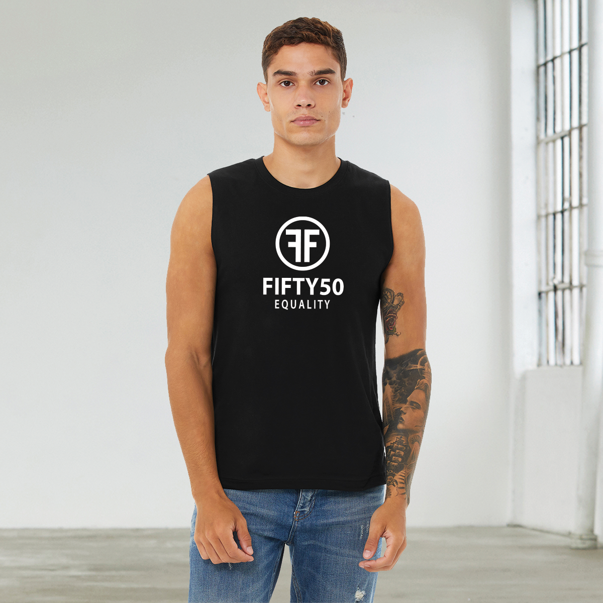 Man wearing a black equality muscle tank top with a white logo. The text says Fifty50, Equality and the logo is two Fs, back to back, with a circle around it.